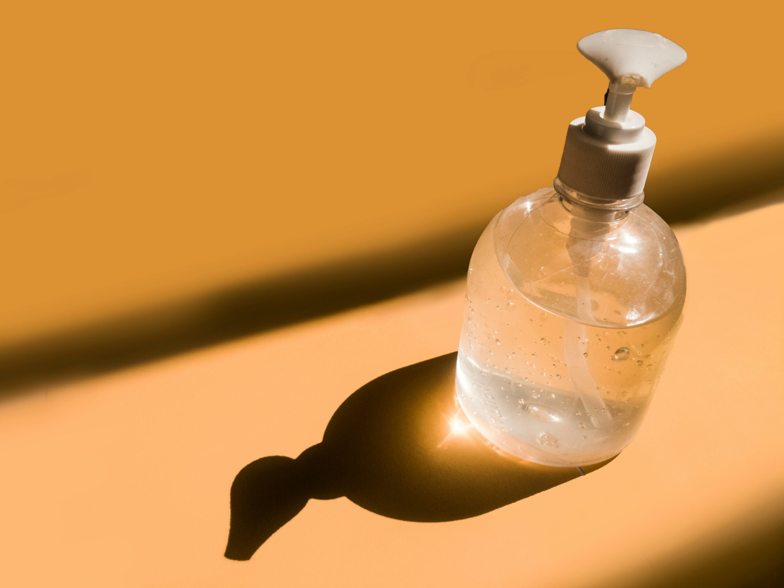 liquid-soap-dispenser-private-label.jpg Clear liquid soap in a pump bottle with warm lighting, representing modern private label soap packaging<br />